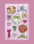 A sticker sheet with dog characters from Bobbie Good with bows on.