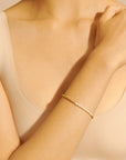 A gold and pearl bracelet.