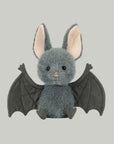 A grey bat shaped stuffed animal toy.
