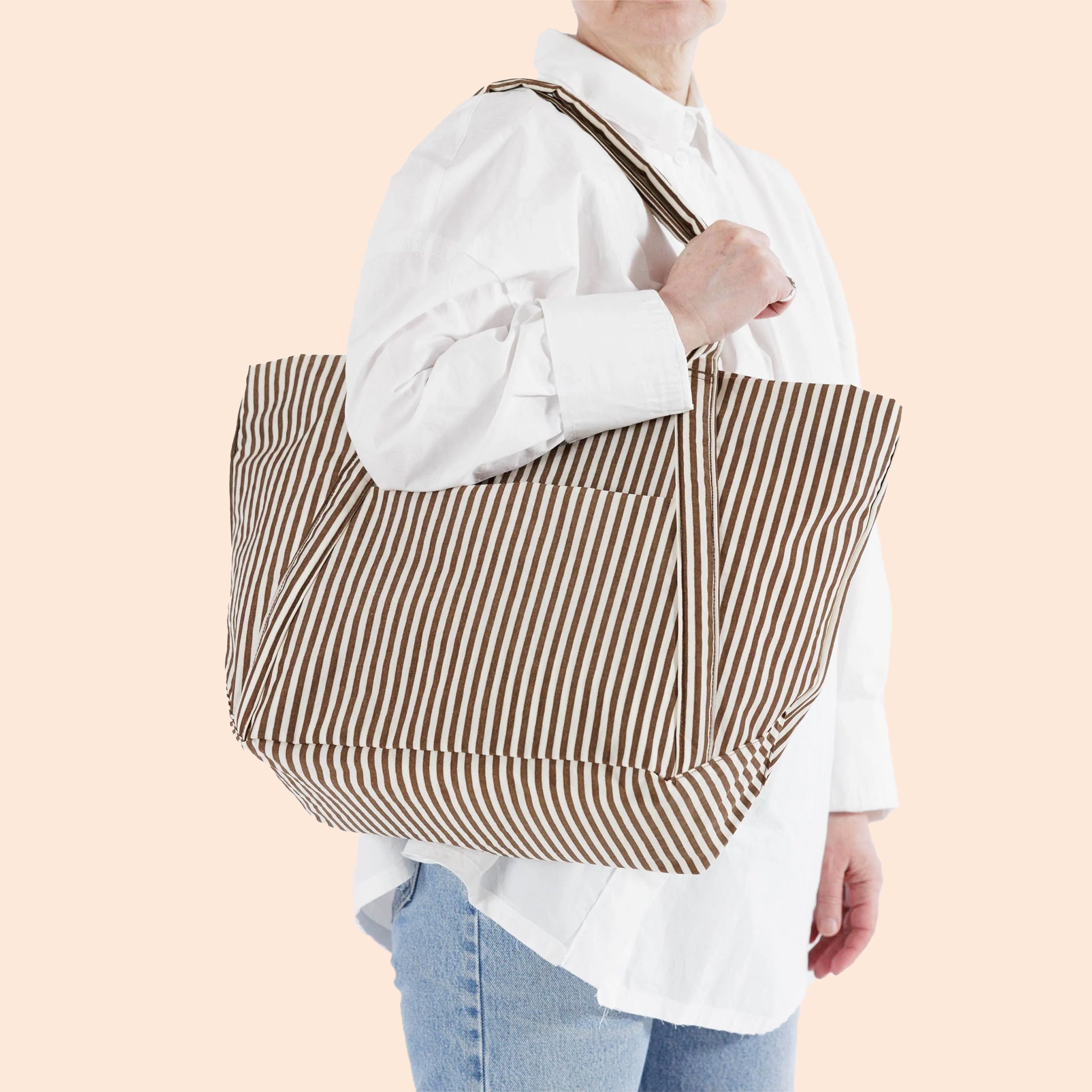 A brown stripe tote bag with a shoulder strap.