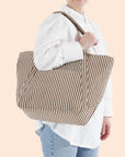 A brown stripe tote bag with a shoulder strap.