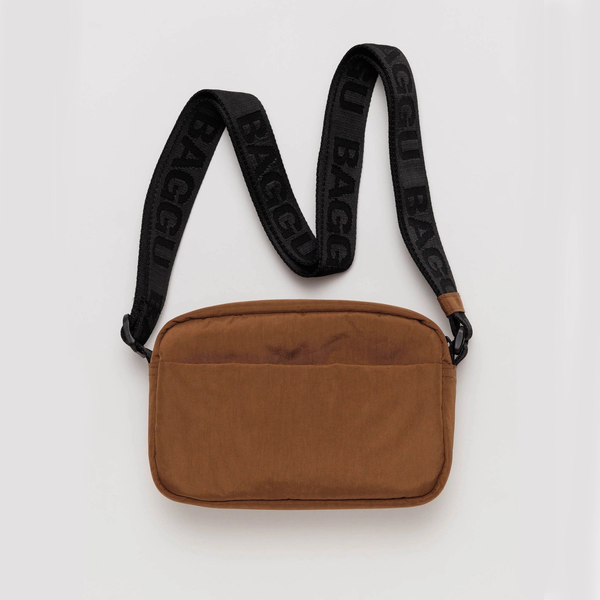 On a white background is a brown rectangle crossbody bag with a black strap.