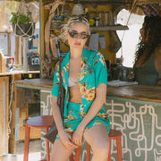 A teal and yellow tropical button up shirt.