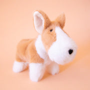 A tan and white corgi shaped stuffed animal.