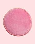 A round pink pillow.