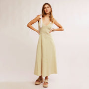 A green and cream striped dress with tie strap details.