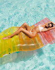 A pink, orange and yellow ombre chaise lounge pool float.