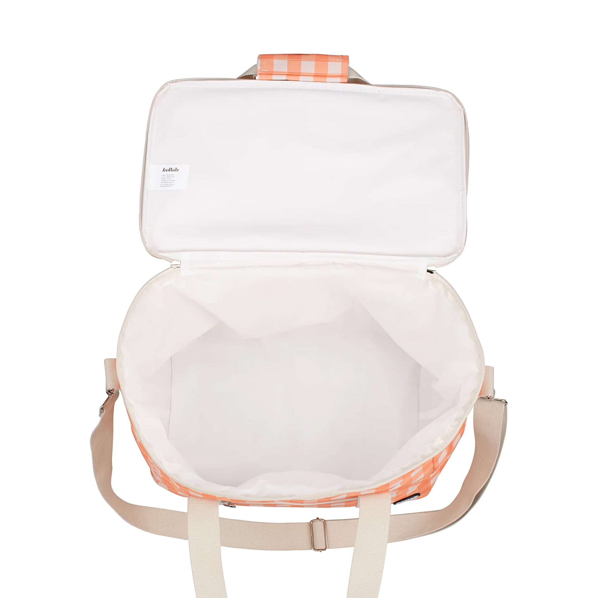 An ivory and apricot checkered print picnic bag with white straps and zippers.