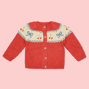 A red sweater cardigan with cherry and bow patterns.