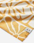A yellow floral print kitchen towel.