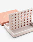 On a white background is a tan four in a row board game in a salmon pink box.