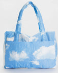 A puffer material bag with a blue and white cloud print.