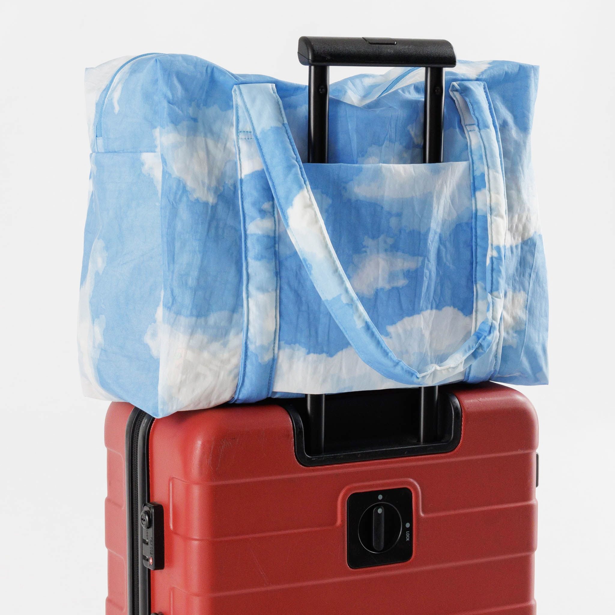 A puffer material bag with a blue and white cloud print.