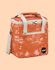 An orange mini cooler bag with a coastal pattern and ivory canvas straps and handles.