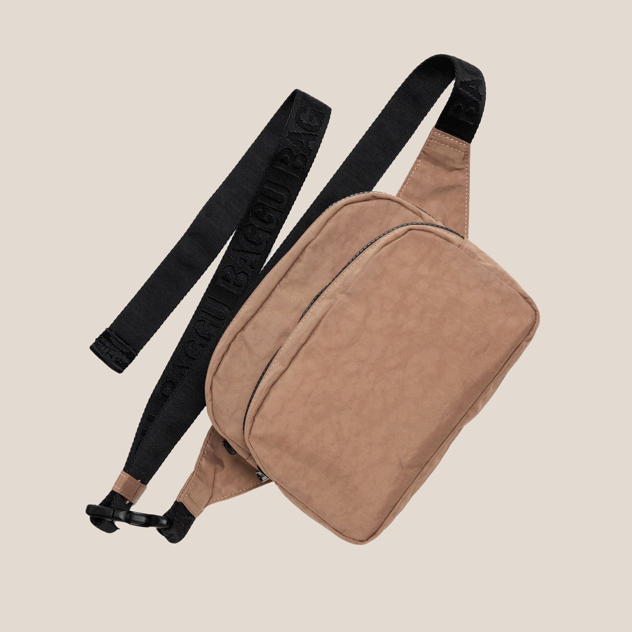 A light brown nylon fanny pack with a black strap and details.