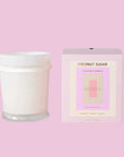 A white candle with a cool toned pink box with text that reads, 'Coconut Sugar Scented Candle'.