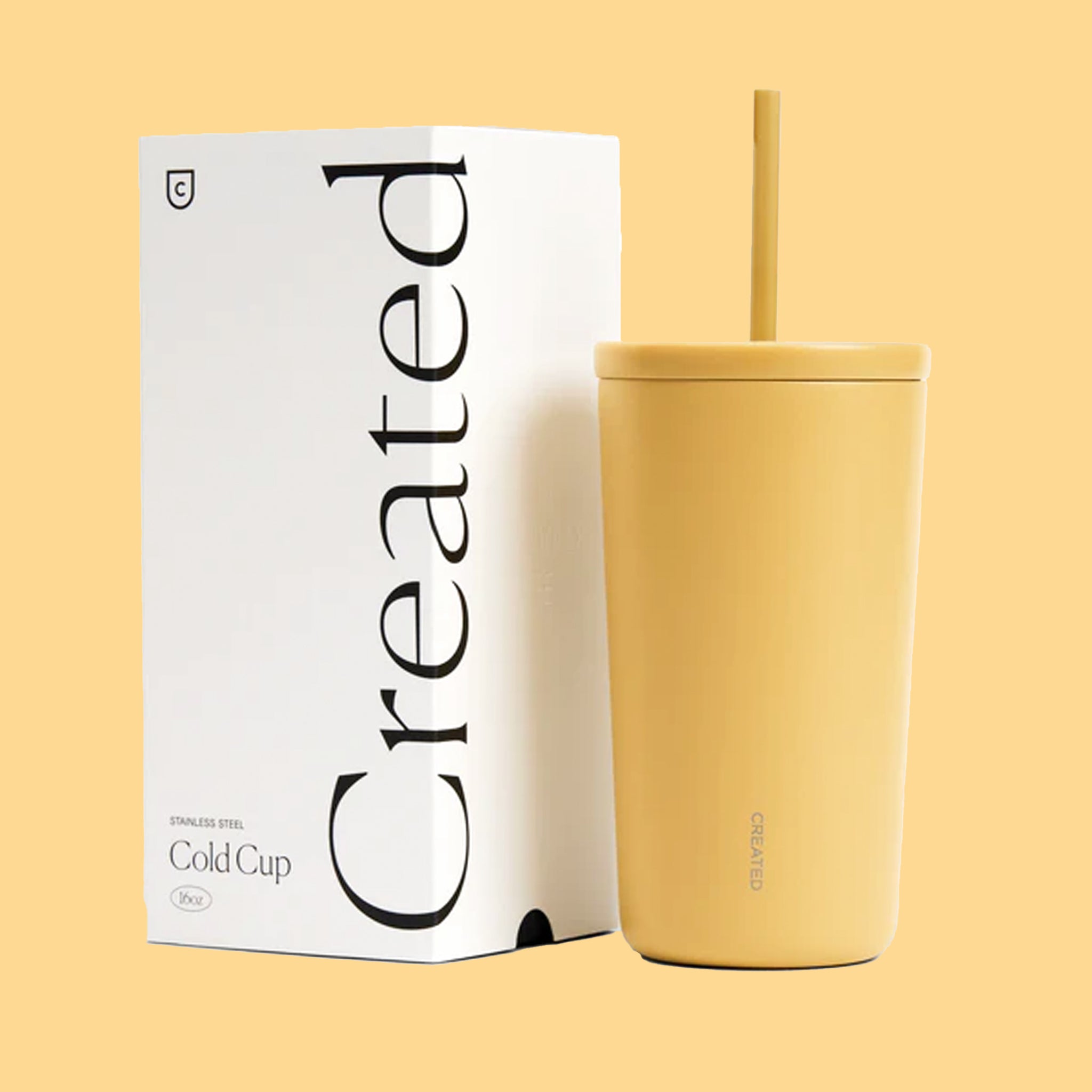 A yellow cold cup tumbler with a straw. 