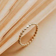 A gold band ring.