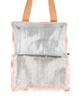 An orange pink and ivory floral print cooler bag.