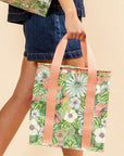A green, white and coral floral printed cooler bag.