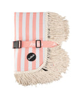 A coral and ivory stripe picnic mat with a fringe edge and a buckle for folding.