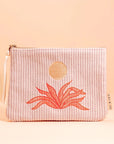 A light pink corduroy pouch with a sun and an orange aloe plant graphic in the center. The pouch has a single zipper going across the top.