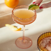 A blush pink coupe glass.