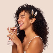 A set of four light pink creaseless clips with a red cherry print.