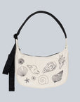 A neutral crescent bag with a black strap and black embroidered shell shaped designs.