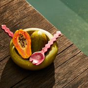 A hot pink pair of resin salad servers.
