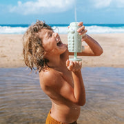 A crocodile shaped beach, pool or bath toy in a green and cream shade.