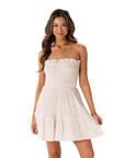 A cream smocked mini strapless dress.
