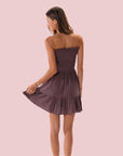 A dark purple ish grey smocked dress with a strapless neckline.