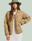 woman wearing light brown quilted jacket