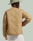 woman wearing light brown quilted jacket