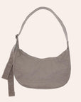 A crescent shaped nylon handbag with a shoulder strap.