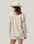 An off white lacey button up long sleeve top.