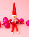 A red elf shaped ornament.