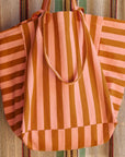 A pink and orange vertical striped canvas tote bag.