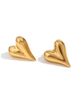 A pair of gold heart shaped earrings.