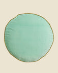 A round velvet jade green floor cushion.