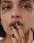 A model wearing the spider web eye patch speckles.