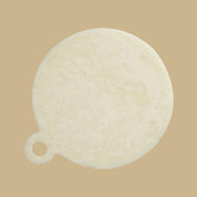 An ivory circle shaped resin board.