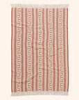 A brown and dark brown bath towel with a wavy design and fringe edge.
