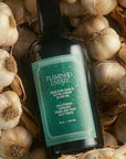 A bottle of olive oil with a green label that reads, 'Flamingo Estate Heirloom Garlic Extra Virgin Olive Oil'.