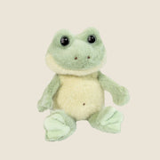 A fuzzy frog shaped stuffed animal.