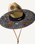 A neutral straw sun hat with a blue, orange, ivory and tan floral and bronco print.