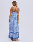 a blue flowy floral maxi dress with tie shoulder strap details.