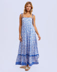a blue flowy floral maxi dress with tie shoulder strap details.