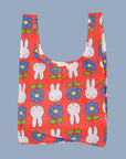A red nylon bag with a Miffy and flower print.